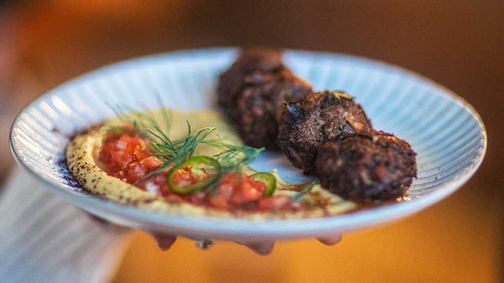 Smokey eggplant, hummus, and pan-fried chicken liver meatballs at Fuel By Night